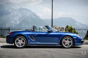 Side profile photo of a beautiful 3rd generation Porsche Boxster convertible in Civenna, Lombardy, Italy.