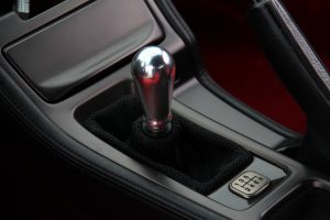 Shifter box of a 1998 Acura NSX with a titanium shift knob