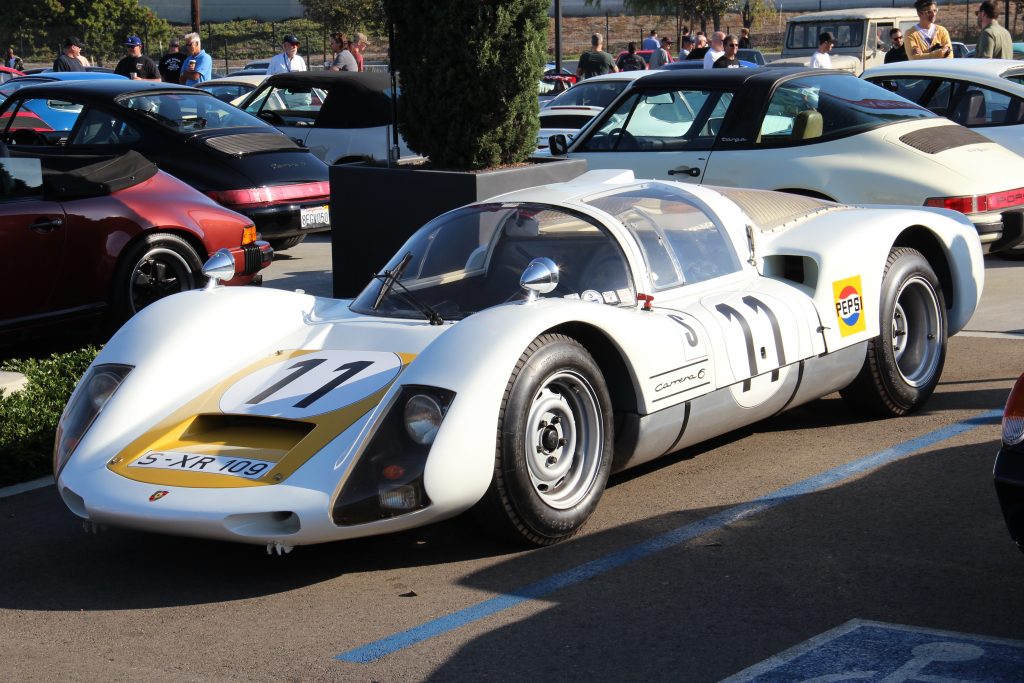 Porsche 906 Carrera 6 race car in white and grey with number 11 livery