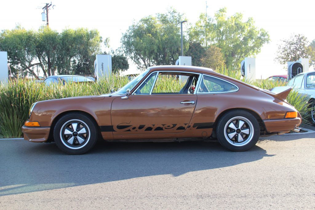 Porsche 911 classic brown color in side profile with "Carrera" decal on side