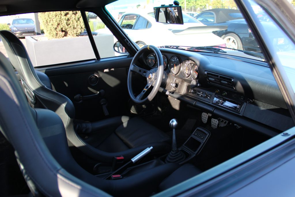 Interior of Porsche 911 with racing seats and aftermarket steering wheel