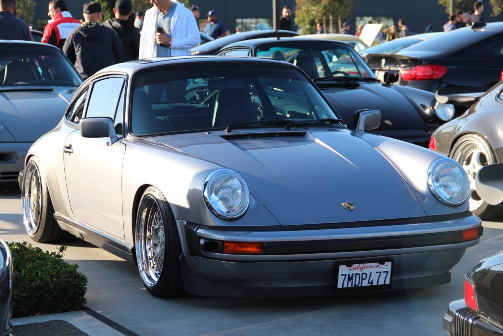 Classic Porsche 911 in matte grey with silver and gold mesh wheels
