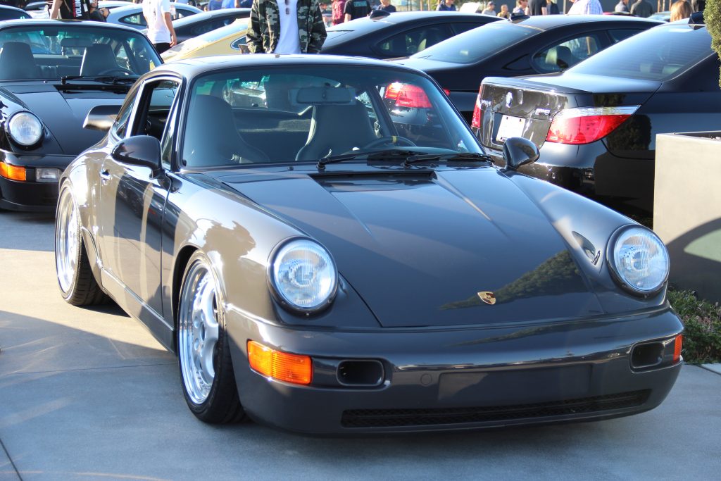 Porsche 911 964 in grey color with aftermarket wheels