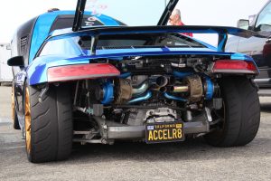 A blue Audi R8 V10 with rear bumper removed showing its twin turbo system