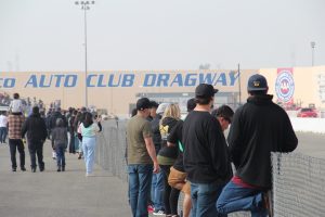 Fans watch drag racing at Auto Club Dragway in Fontana, California