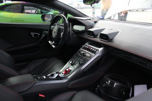 Interior of a Lamborghini Huracan, mostly black with red piping