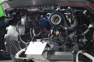 The engine bay of a twin turbo Lamborghini Huaracan, shown from the rear, showing many of the turbo system components